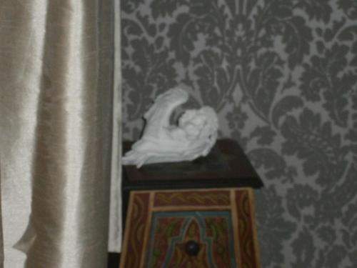 a statue sitting on a table in a room at Art Apartments in Poznań