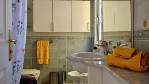 a bathroom with a sink and a toilet at Atico Carlota- Feel Canarias ! in Chayofa