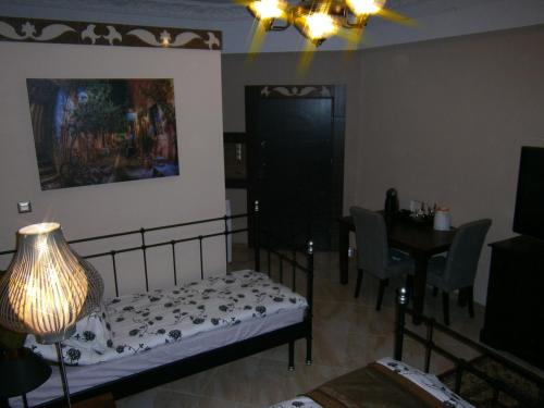 a bedroom with a bed and a table and a lamp at Art Apartments in Poznań