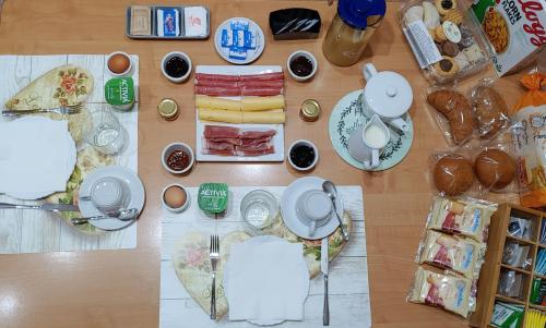a table topped with plates and food on a table at Locazione Turistica Arcobaleno "Family Loft" in Roccavivara