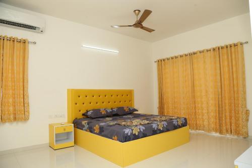 a bedroom with a bed and a ceiling fan at The best villa stay- family friendly in Coimbatore