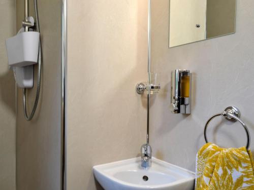 a bathroom with a white sink and a mirror at Derwent - Uk1406 in Applethwaite