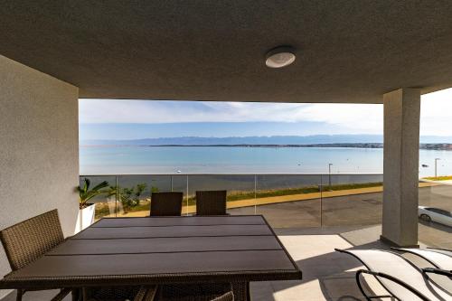 a dining room with a table and a view of the ocean at Golden Nin in Nin