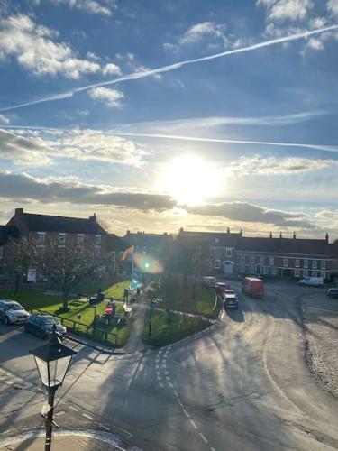 a view of a street with the sun in the sky at Innkeeper's House in Easingwold