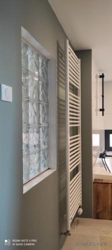 a kitchen with a window filled with dishes at GITE AU PETIT RUISSEAU-Etage et combles-maison alsacienne 4 personnes 4 nuitées minimum in Langensoultzbach