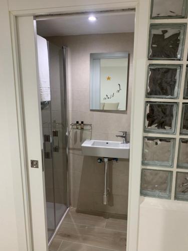 a bathroom with a sink and a shower at La Vida es Bella in Setenil