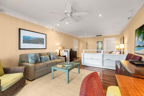 a living room with a couch and a table at Turtle Bay Villas in Kahuku