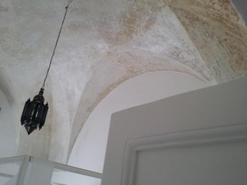 a chandelier hanging from a ceiling in a room at Corte Moline in Gallipoli