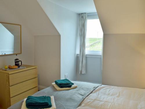 a bedroom with a bed with two towels on it at Brick Cottage 2-uk13675 in Palnure