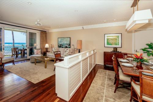 a dining room and living room with a dining table at Turtle Bay Villas 205 in Kahuku
