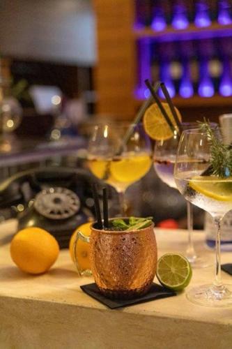two glasses of wine and lemons on a table at Hotel Sliško in Zagreb