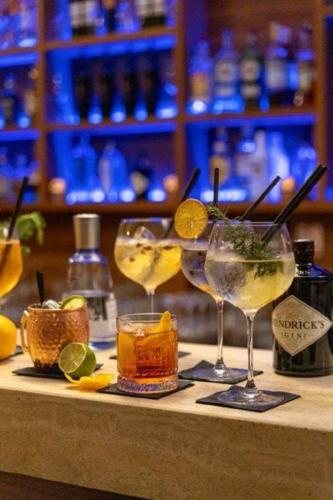 a group of glasses sitting on top of a bar at Hotel Sliško in Zagreb