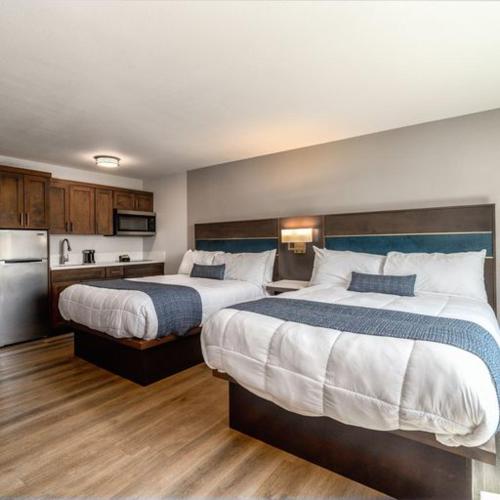a hotel room with two beds and a kitchen at MainStay Suites Moreno Valley Near March Air Reserve Base in Moreno Valley
