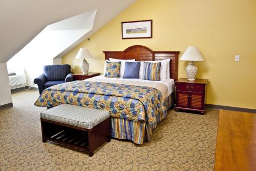 a hotel room with a bed and a chair at Oceancliff I & II, a VRI resort in Newport