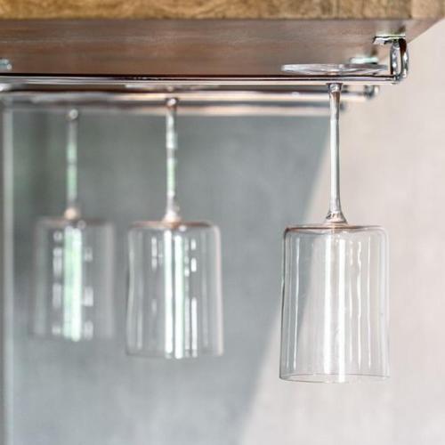 three wine glasses hanging from a metal rack at MainStay Suites Moreno Valley Near March Air Reserve Base in Moreno Valley