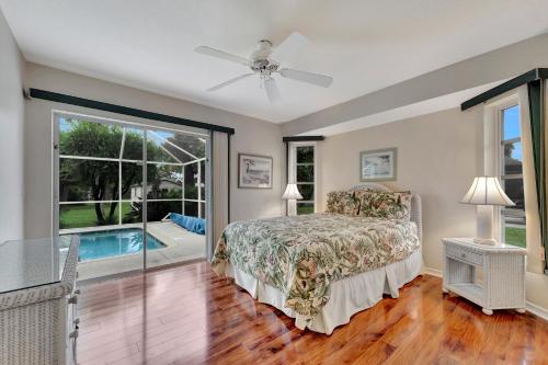 a bedroom with a bed and a pool at Tropical Oasis in Port Charlotte