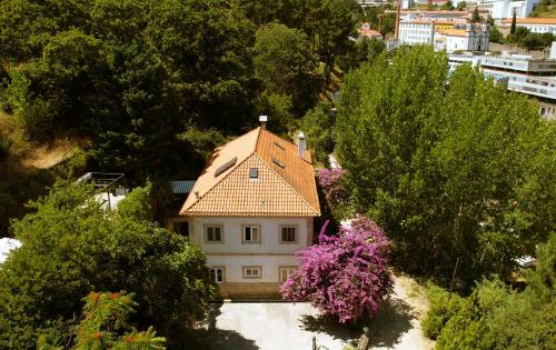 an aerial view of a house with a roof at Casa das Essências, Quinta de Santo António in Covilhã