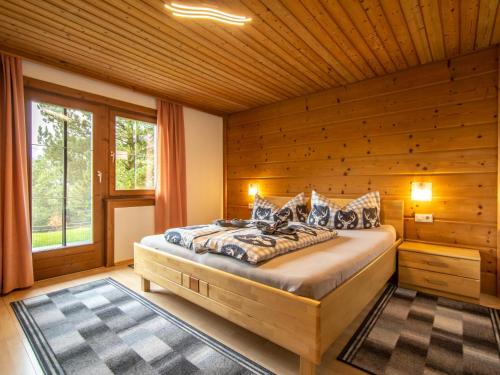 a bedroom with a bed in a wooden room at Chalet Rosa in Reith im Alpbachtal