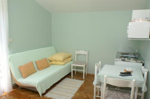 ein Wohnzimmer mit einer Couch und einem Tisch in der Unterkunft Studio Vodice 4172a in Vodice