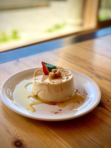a piece of cake on a plate on a table at Nassamat Boutique Hotel in Al Bārūk