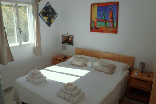 a bedroom with two beds with towels on them at Ostuni home nature in Ostuni