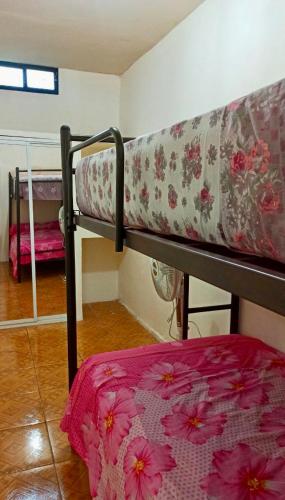 Etagenbett in einem Zimmer mit einer Blumenmatratze in der Unterkunft Departamento la comodidad de tu casa in Machala