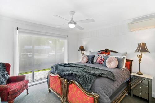 a bedroom with a bed and a window at Centrally located in the heart of the King Valley in Whitfield