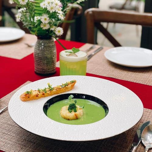 a plate of food on a table with a bowl of soup at Amaya Retreat in Sóc Sơn