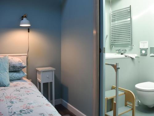 a bedroom with a bed and a sink and a toilet at Primrose in Scruton