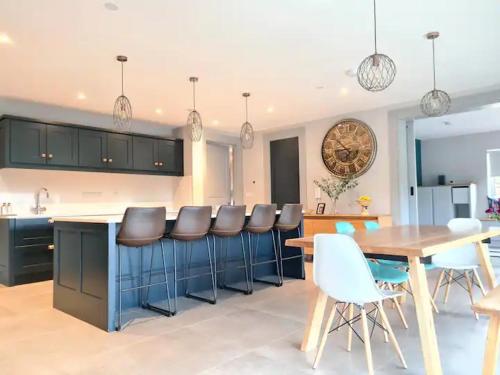 a kitchen with a table and chairs and a dining room at Exquisite Galway City Luxury home – Sleeps 10 in Galway