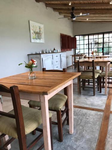 a dining room with a wooden table and chairs at Finca el Maitén Hotel Boutique in San Rafael