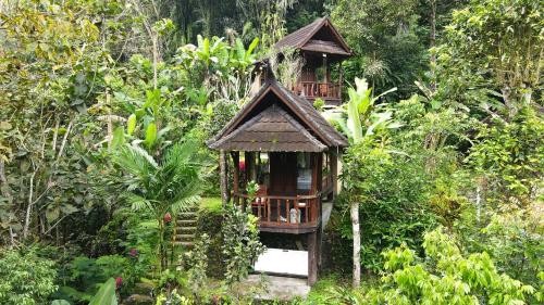 a small tree house in the middle of a forest at Bali Jungle Resort in Tegalalang
