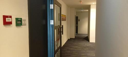 a hallway of an office building with a door and a hallway at Roxy Hotel Sri Aman in Simanggang