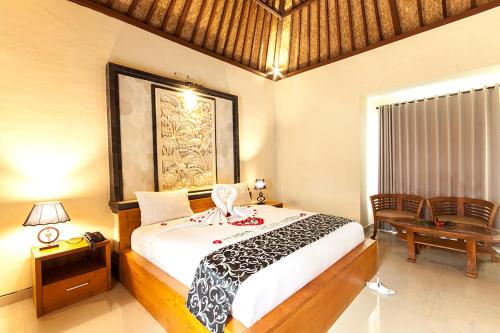 a bedroom with a large bed and a table and a desk at Bali Jungle Resort in Tegalalang