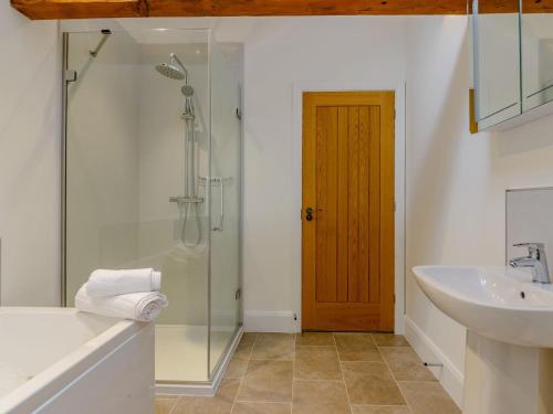 a bathroom with a glass shower and a sink at Church Manor in Carlton