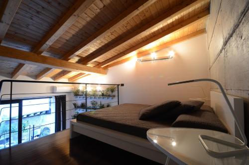 a bedroom with a bed and a glass table at Pietranera Apartments in Catania