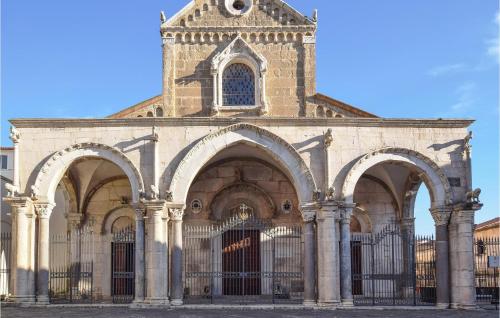a large building with a gate and a church at Gorgeous Home In Carano With Kitchen in Carano