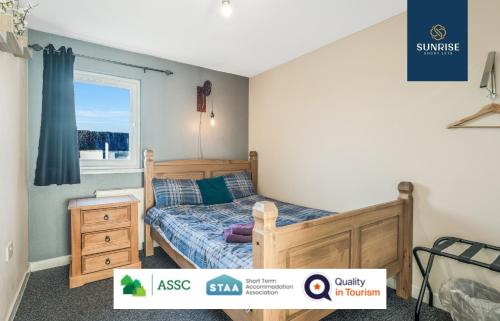 a bedroom with a bed and a window at THE LAW, 4 Rooms with TVs, 2 Bathrooms, Central, Free Parking, Fully Equipped, Long Stay Rates Available visit SUNRISE SHORT LETS in Dundee