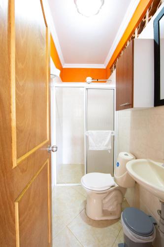 a bathroom with a toilet and a sink at Apartamentos Primavera in Jardin