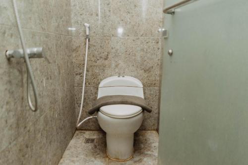 a bathroom with a toilet with a towel on it at DS Colive 34 in Semarang