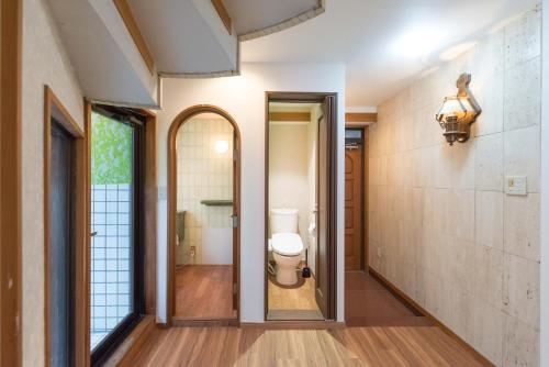 a bathroom with a toilet and a window at TORA HOTEL Tokyo-Rikugienn 寅ホテル 六義園 C in Tokyo