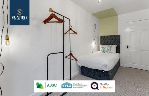 a hotel room with a bed and a sign on the wall at 3 Bedroom Law, Contractors' FAVOURITE, Free Parking, WiFi, Sleeps 4, Tourists, Relocation, Business Travellers, Short - Long Extended Stays in Dundee