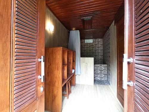an open door to a room with wooden walls at Bali Jungle Resort in Tegalalang