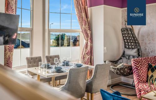 a dining room with a table and chairs and a window at PRESIDENTIAL APARTMENT, Family Home, Luxury Bedrooms, 2 Rooms, 1 King Bed, 2 Single Beds, Free WiFi, Free Parking, FAVOURITE for Families, Tourists, Business Travelers, Relocation, Beautiful River Views by SUNRISE SHORT LETS in Dundee