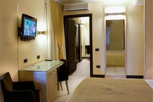 a hotel room with a bed and a television at Hotel Imperial in San Benedetto del Tronto