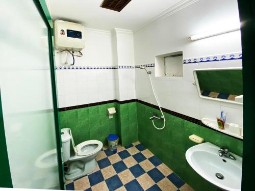 a bathroom with a toilet and a sink at Alex Ha Long Hotel in Ha Long