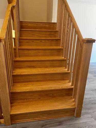 a wooden staircase in a room with wooden floors at NEWLY BUILT LUXURIOUS 3BRM TOWN HS/AIRPORT/PARKING in Brampton