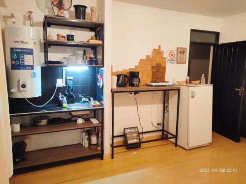 una cucina con bancone e frigorifero in camera di Renovado departamento céntrico a mts de peatonal a Mendoza