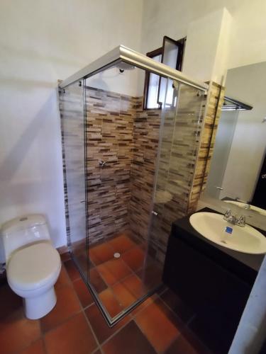 a bathroom with a shower and a toilet and a sink at Mirador de la cuesta in Tres Esquinas