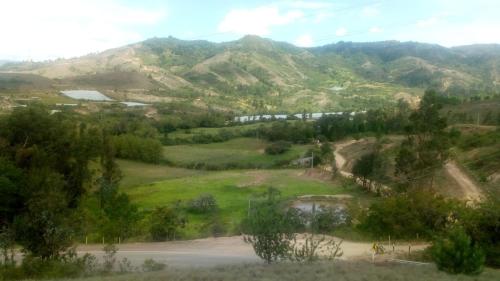a view of a valley with a mountain at Mirador de la cuesta in Tres Esquinas